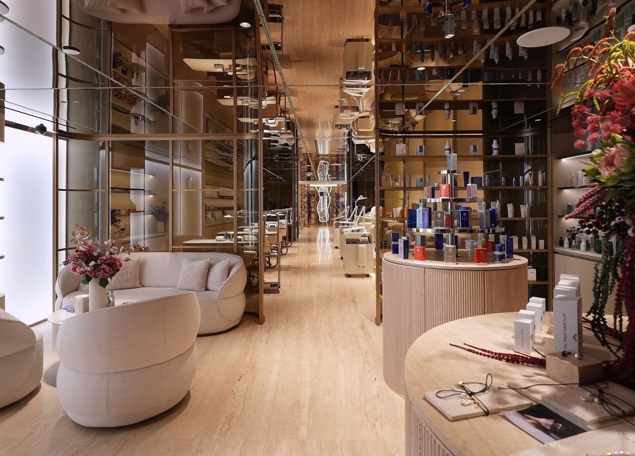 Leo Beauty Club Dubai — warm golden salon interior on Palm Jumeirah with curved seating and product displays